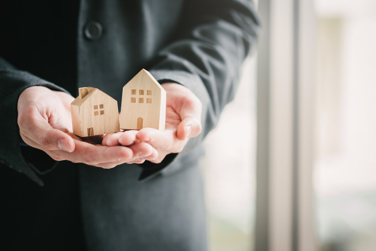 businessman presenting wooden house.real estate concept