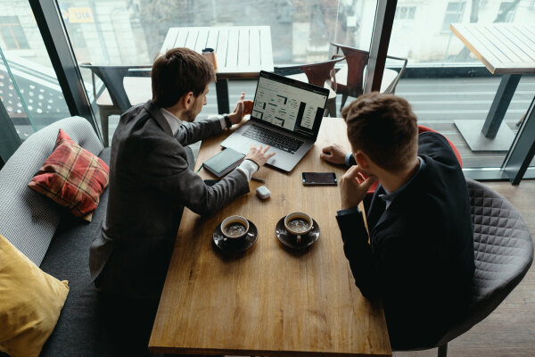 Two young businessman having a successful meeting at restaurant.